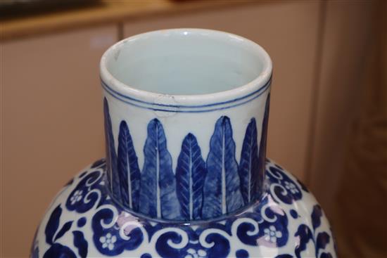 A large blue and white Chinese and a smaller similar vase with wooden cover, two stands and a cover